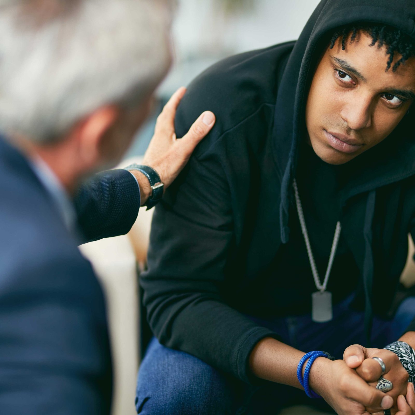 Begeleider in gesprek met jongere tijdens specialistische jeugdzorg begeleiding